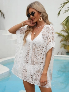 Detailed view of white crochet beach cover-up featuring intricate hollow-out geometric patterns