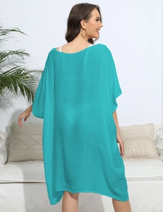 Detail showing the light lake blue crochet fabric and loose fit of this summer beach cover-up