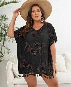 Detail of black crochet lace cover-up featuring fringe hem and floral cut-out patterns