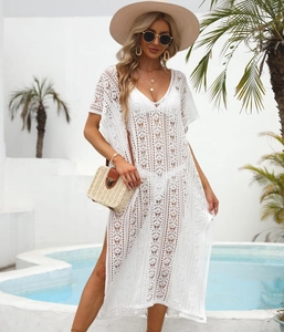 Macro shot of white crochet beach cover-up featuring geometric floral cut-out patterns