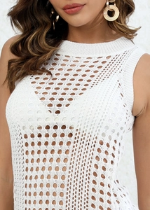 Detailed close-up of white knit hollow-out vest with geometric crochet patterns and textures