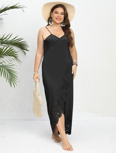 Detail of laser-cut openwork pattern and side slit on this black beach maxi dress