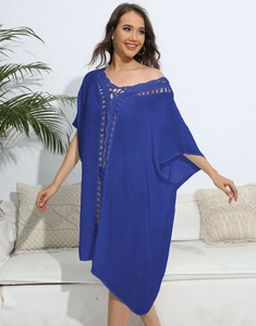 Detail of crochet neckline on navy blue loose beach dress with a bohemian vacation vibe