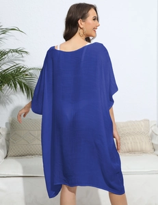 Detail of blue beach kaftan with deep V-back design and textured loose fit fabric