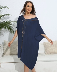Detail of navy blue V-neck beach cover-up with crochet embroidery and batwing sleeves