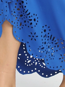 Detail of laser-cut floral pattern and镂空 texture on royal blue beach dress fabric