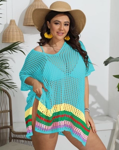 Detail of teal crochet beach cover-up featuring colorful rainbow striped hemline