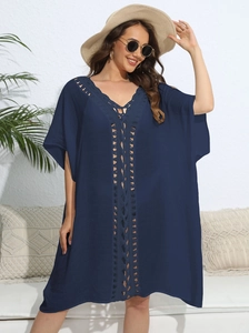 Detail of navy blue crochet lace v-neckline on a loose summer beach cover-up dress