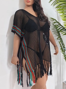 Detail of crochet beach cover-up featuring turquoise stripes and tassel fringes