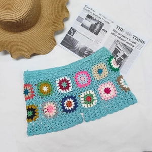 Detail of colorful granny square crochet beach shorts with a bohemian pattern design