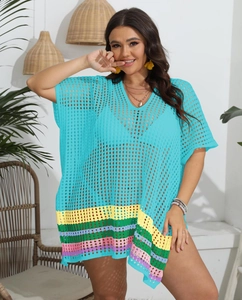 Close-up of bohemian crochet beach cover-up featuring colorful striped hem and hollow knit