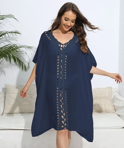 Detail of bohemian navy blue cover up dress with crochet lace patchwork and deep V-neck