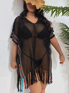 Detail of crochet beach cover-up with color stripe accents and long fringe hemline