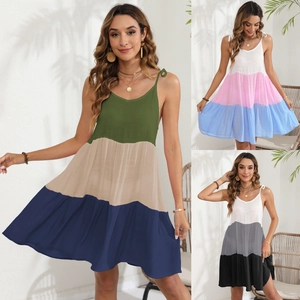 Detailed view of tiered summer sundresses in green, blue, and black color combinations