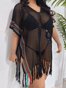 Detail of black crochet beach cover-up featuring colorful stripes and long fringe tassels