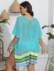 Detail of crochet knit beach cover-up featuring vibrant rainbow stripes and side slits