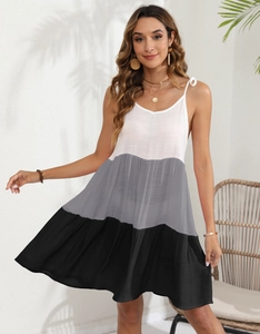 Detail of color-block striped mini sundress featuring white, grey, and black panels