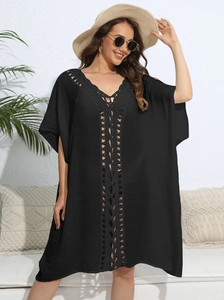 Close-up of black crochet hollow-out beach cover-up with vertical textured details