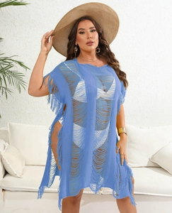 Detailed close-up of blue crochet knit texture with tassel fringe on beach cover-up dress