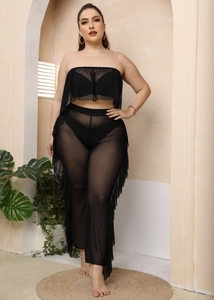 Dettaglio dei pantaloni da spiaggia in mesh nero velato con bordi a balze laterali