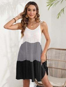 Detail of color-block striped sundress featuring V-neckline and shoulder tie bows