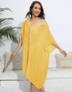 Close-up of bohemian yellow beach cover-up with intricate crochet lace detailing