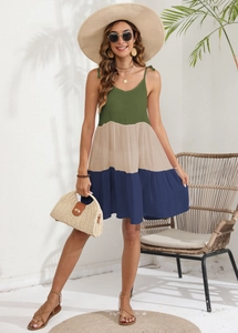 Detail of three-color striped patchwork strap dress showing texture and layered ruffle hem