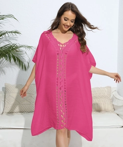 Detail of rose pink beach cover-up featuring hollow crochet embroidery and V-neckline