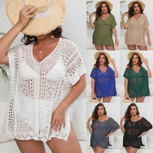 Detail view of crochet beach cover-up showing deep V-neck and geometric hollow patterns