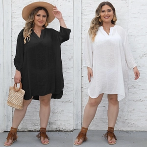 Detail of plus size V-neck beach cover-up with textured fabric in black and white colors