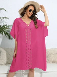 Detail of rose red crochet V-neck beach cover up with intricate knit patterns for women