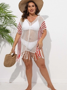 Bohemian white crochet beach cover-up with red stripes and fringe hem on a model