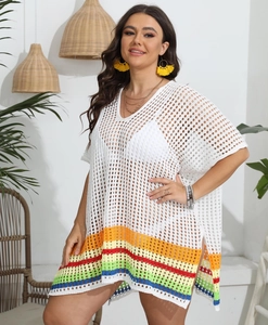Close-up of the rainbow striped hem on a white crochet mesh beach cover-up dress