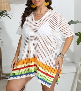 Detail of white crochet beach cover-up featuring colorful rainbow stripes at the hem