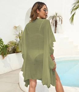 Detail of the olive green chiffon beach cover-up with feminine ruffles and light texture