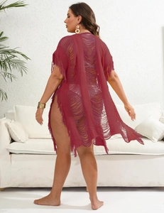 Detail of burgundy knit beach cover-up featuring side slit and elegant long tassels