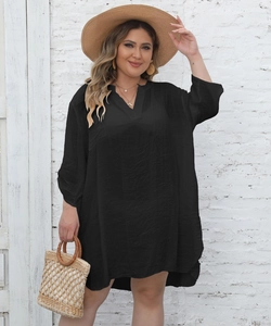Detail of loose black V-neck beach cover-up dress with an irregular hem and long sleeves