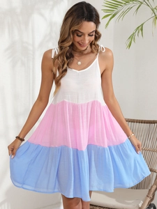 Detail of colorful striped sundress featuring knotted shoulder straps and tiered hem