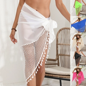 Detail view of colorful chiffon beach sarongs with fringe trim and mesh patchwork