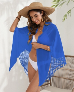 Detail of bright blue beach sarong featuring hollow grid crochet and fringed hem design