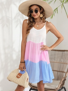 Detail of pink and blue color-block tiered dress with shoulder bow ties and pleats