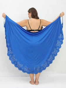Blue laser-cut beach shawl with scalloped edges and intricate floral cutout patterns