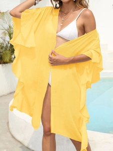 Detail of yellow ruffle sleeve beach cover up with lightweight textured fabric