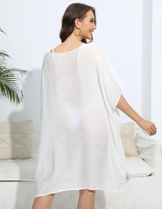 Side view of lightweight white semi-sheer beach cover-up with textured fabric drape