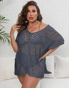 Detail of dark grey crochet beach dress featuring intricate hollow geometric knit patterns