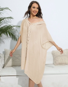 Detailed close-up of bohemian beach cover-up with crochet embroidery and loose sleeves