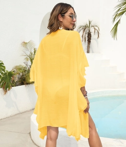 Detail of ruffled sleeves on yellow chiffon beach cover-up cardigan for summer vacation