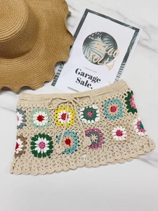 Colorful handmade crochet beach shorts with bohemian flower patches and drawstring waist