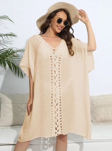 Detailed crochet knitting on the V-neckline of a beige loose beach cover-up for women