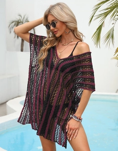 Detailed knit texture of a black and magenta striped hollow beach cover-up for women